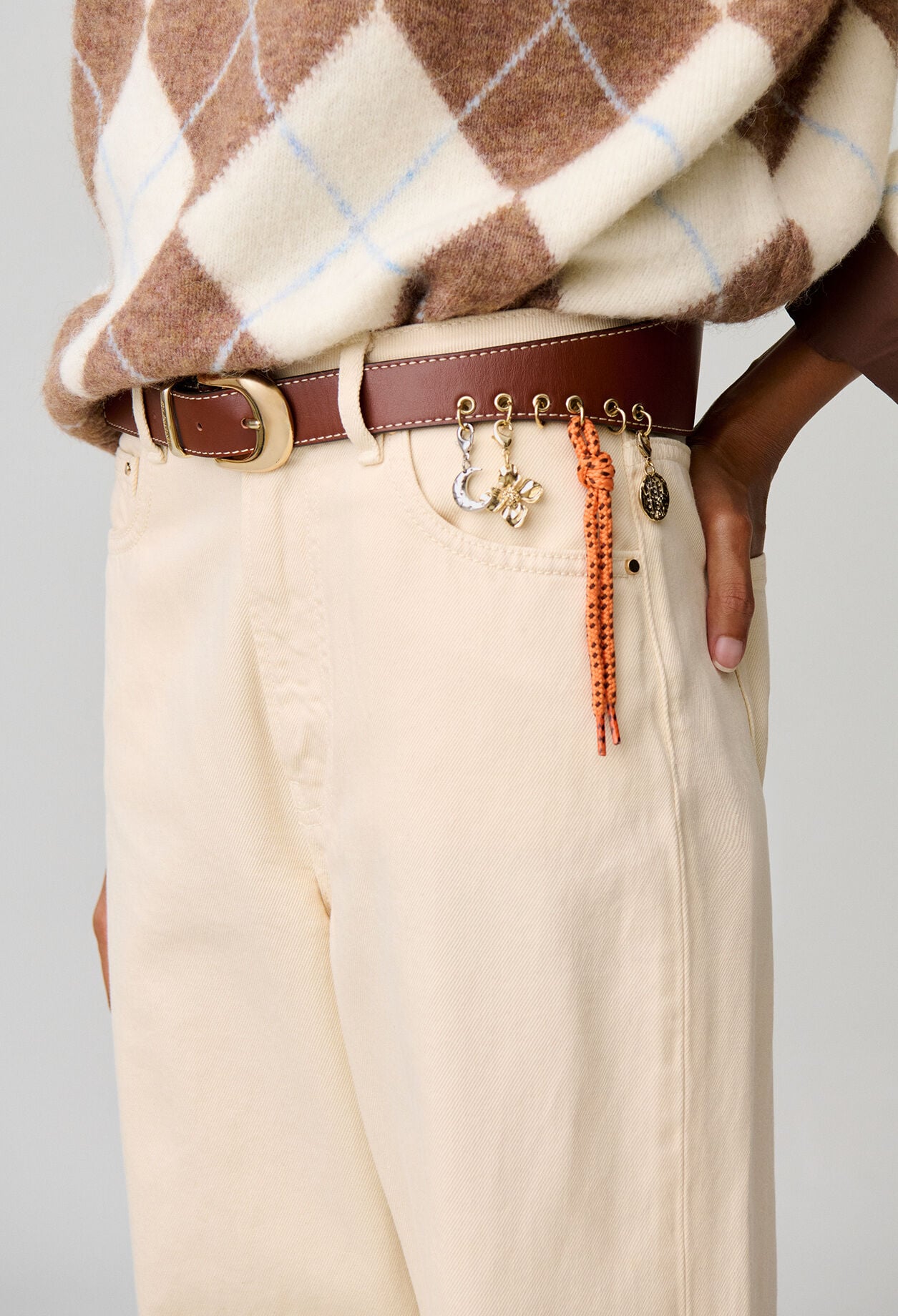 Leather eyelet belt with charms
