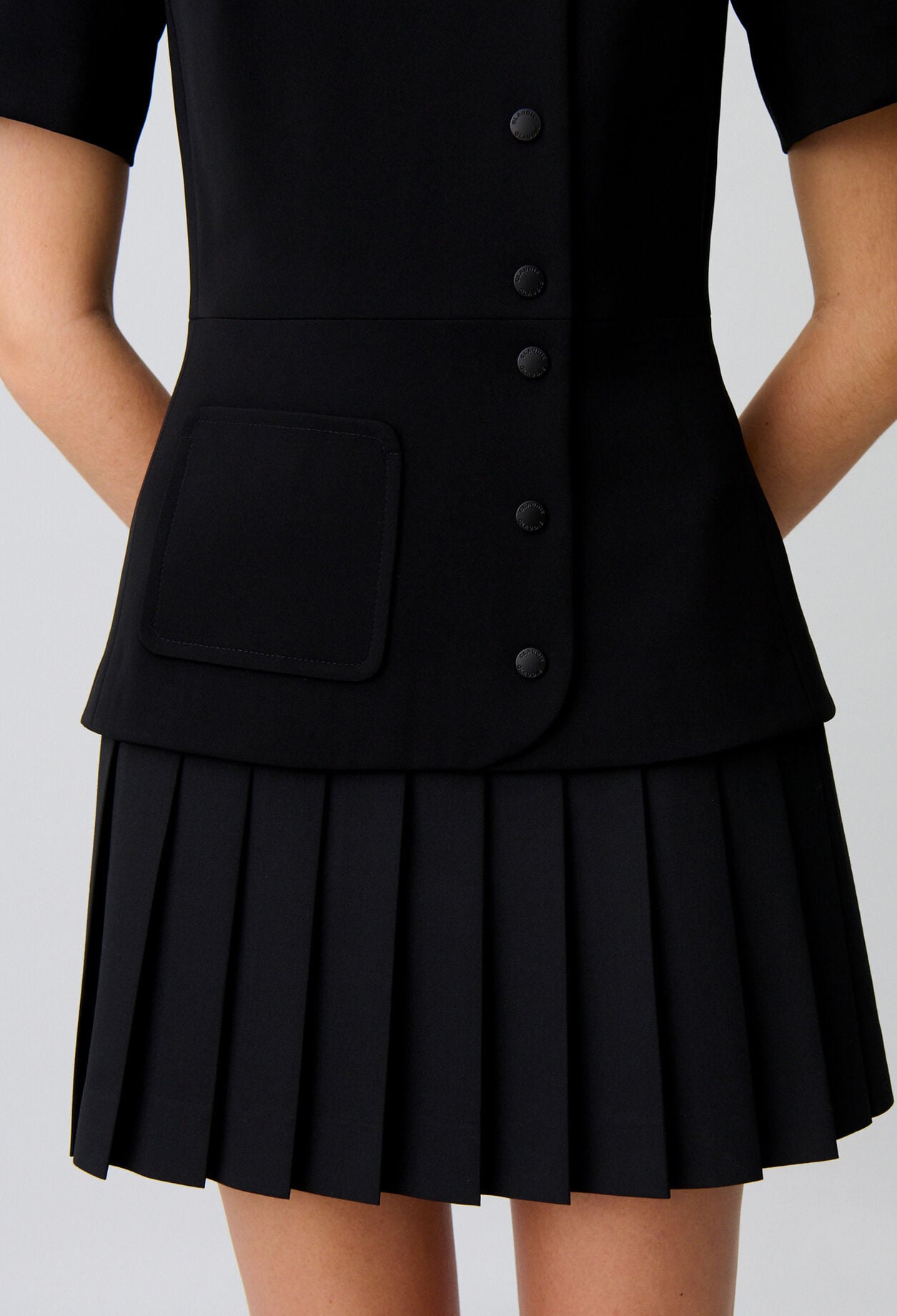 Short pleated peplum dress